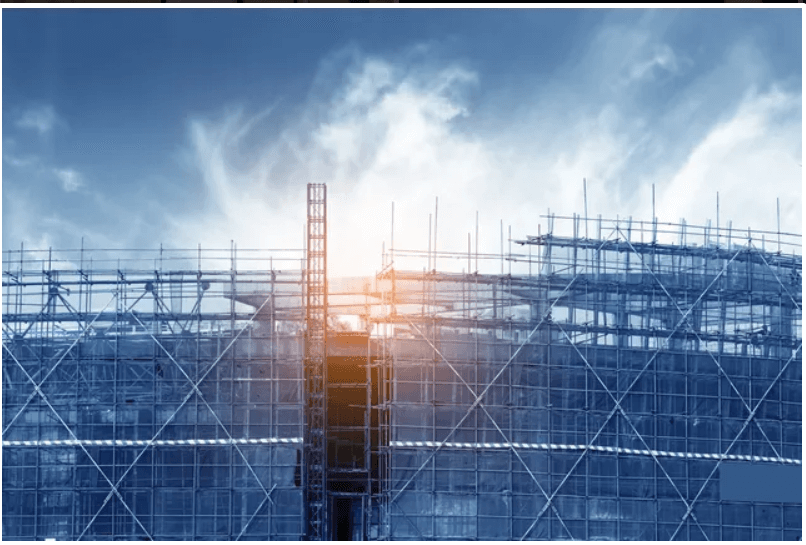 Construction site with scaffolding at sunrise.